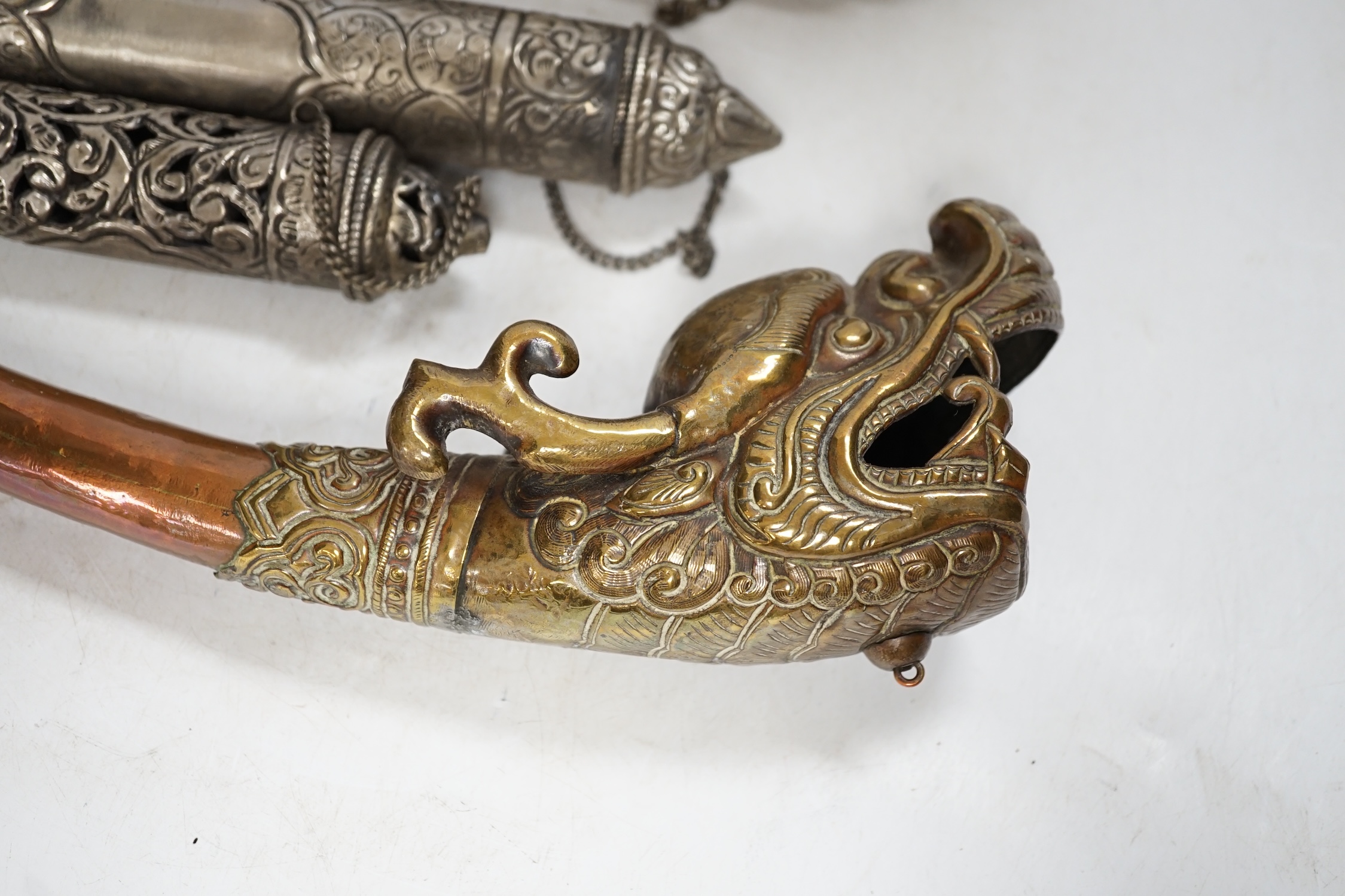 Three Tibetan scroll holders and a 'dragon' trumpet, trumpet 38cm long. Condition - fair to good